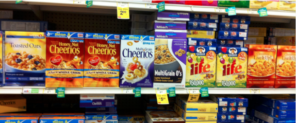 Breakfast Cereal boxes on the shelf with multiple flavors of the same brands. Honey Nut, Multigrain Cheerios and O's. Life and Live it Up